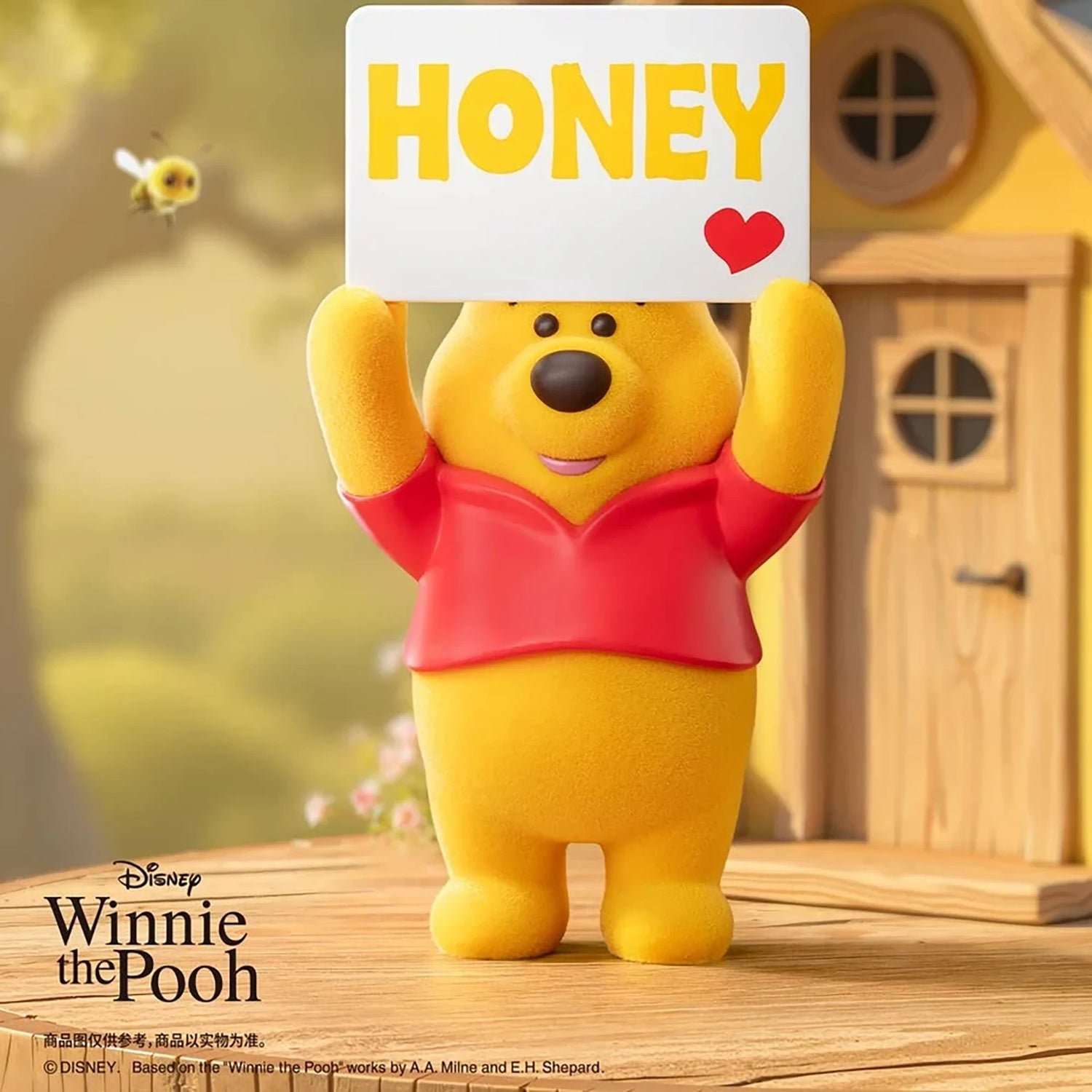Yellow bear figure holding a “HONEY” sign with a red heart