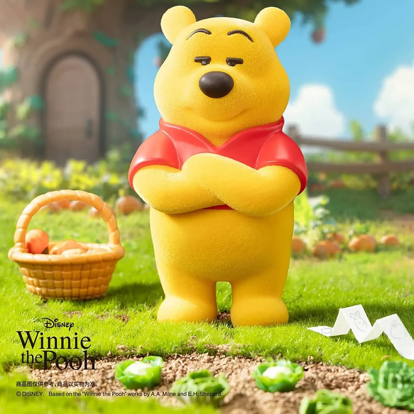 Yellow bear figure in a red shirt with arms crossed, beside a basket