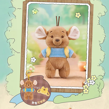 Small brown plush mouse with large ears wearing a blue shirt and yellow backpack standing against a soft outdoor background