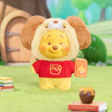 Plush keychain bear in red shirt with emblem, holding a small storybook tag.