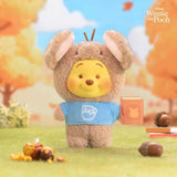 Brown rabbit-eared plush keychain with Pooh face, blue shirt, and orange book tag.