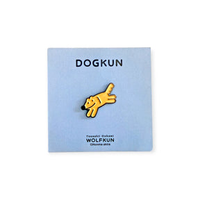 Orange cartoon dog thumb-up enamel pin on a light blue display card