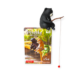 Black bear figure fishing with dangling feet from Fishing Animals Blind Box Vol 3 packaging, gallery position 1